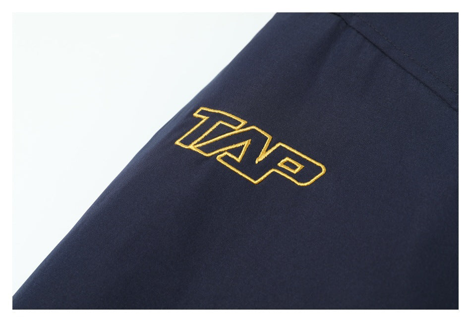 Gold embroidered lettering on dark navy fabric.