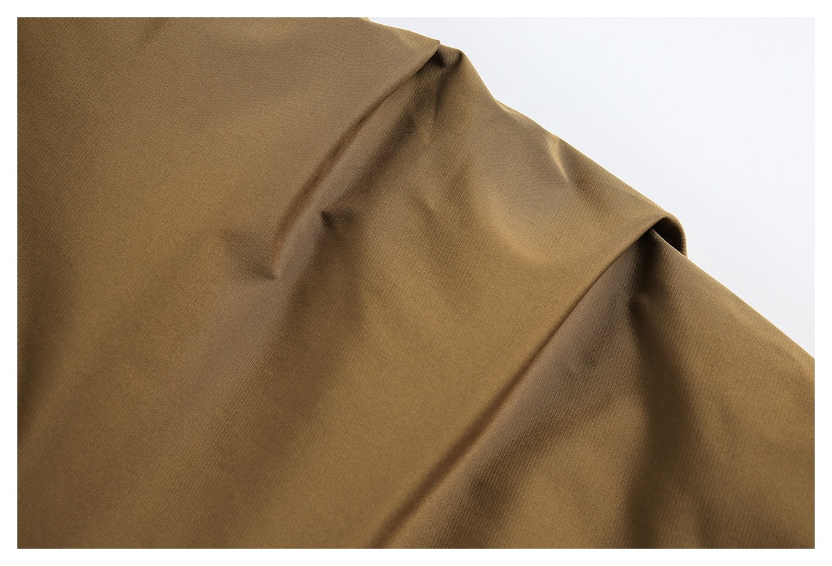 Close-up showing the plain brown jacket fabric and its smooth surface.