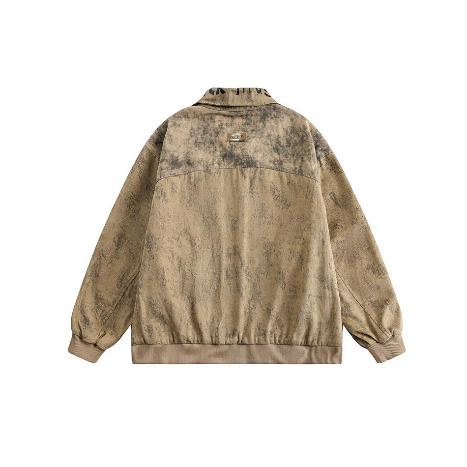 Back view of a mottled tan-brown jacket with a high collar, long sleeves, ribbed cuffs and hem, and a small upper-back patch.