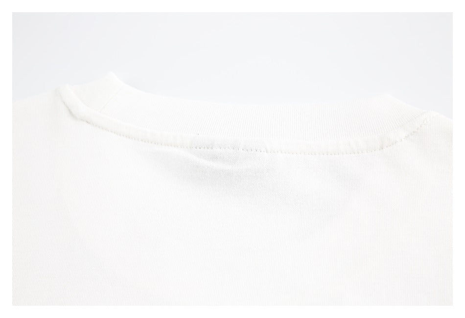 Close-up of the white garment's rounded neckline and ribbed collar.