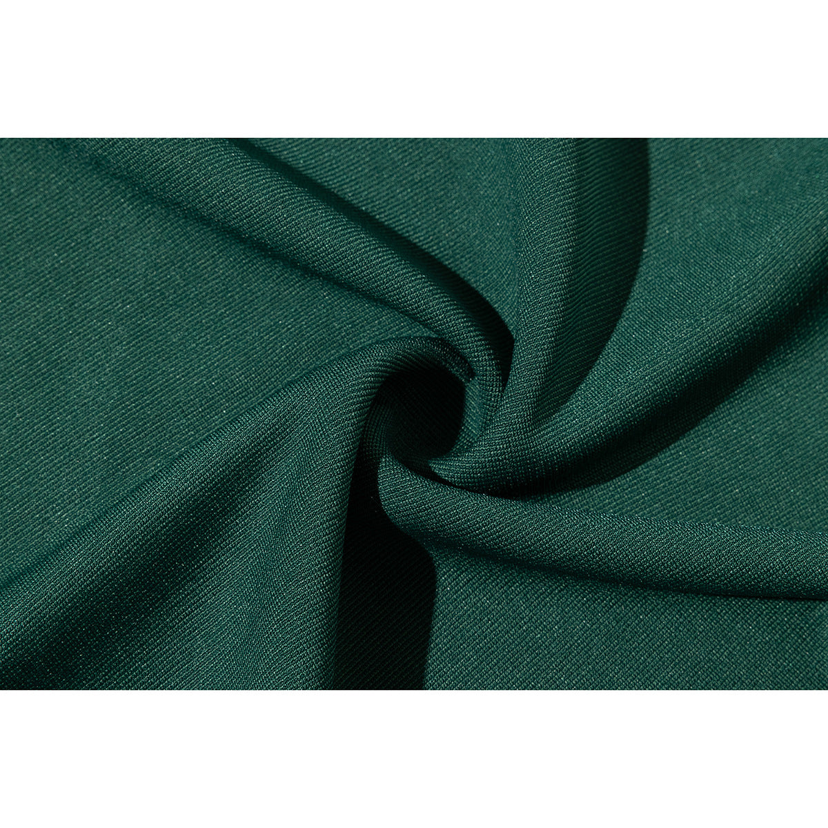 Extreme close-up of dark green fabric gathered into folds, showing its fine textured weave.