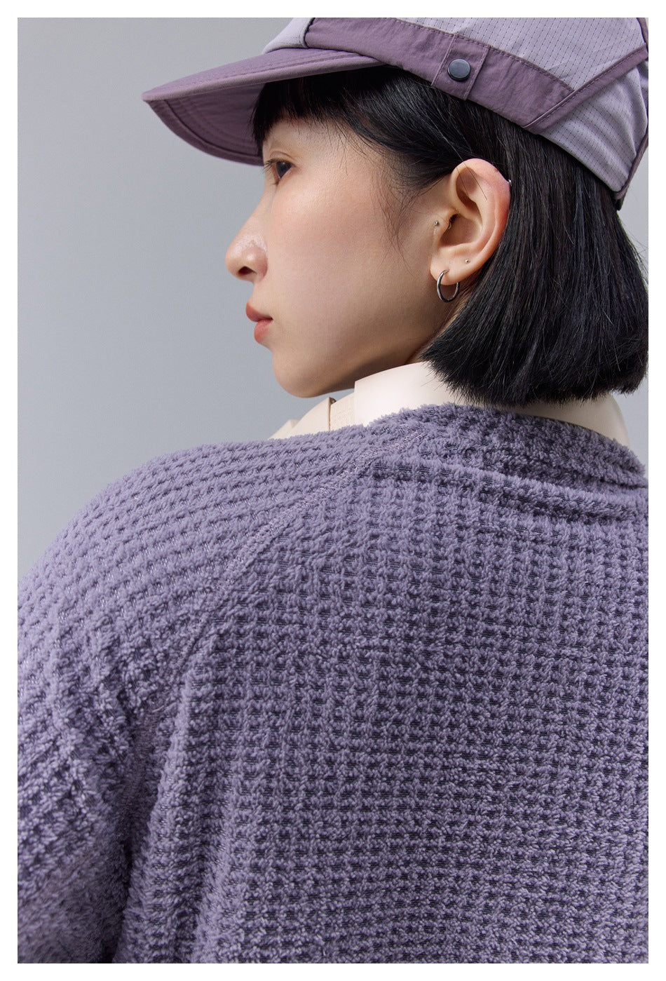 Close-up of the textured lavender jacket fabric across the shoulder and upper back.