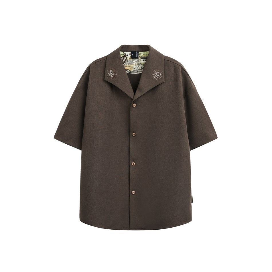 Mocha brown short-sleeve button-front shirt with notched collar, embroidered leaf motifs and printed inner collar