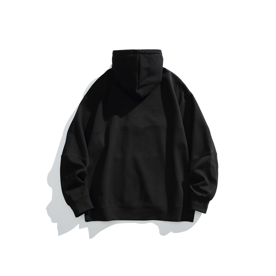 Back view of a plain black pullover hoodie laid flat against a white background.