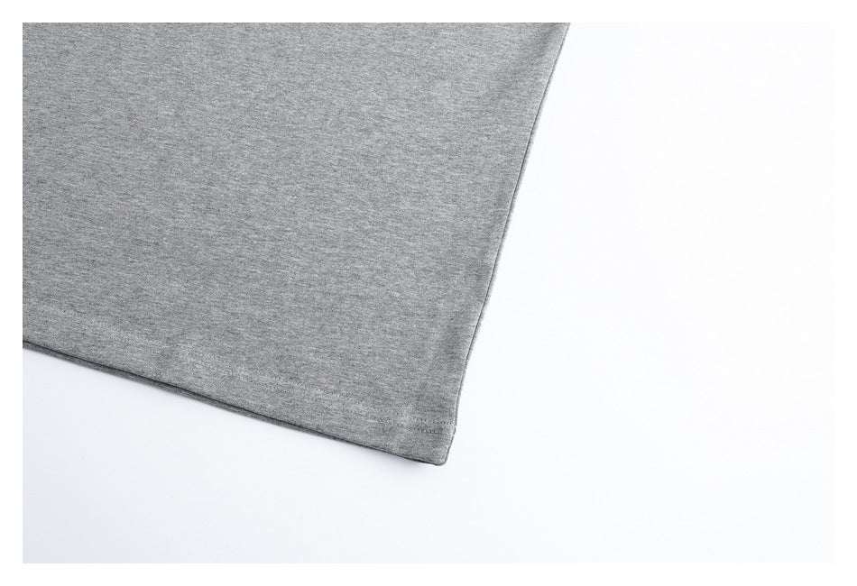 Close-up of the gray top's straight hem and fabric surface.