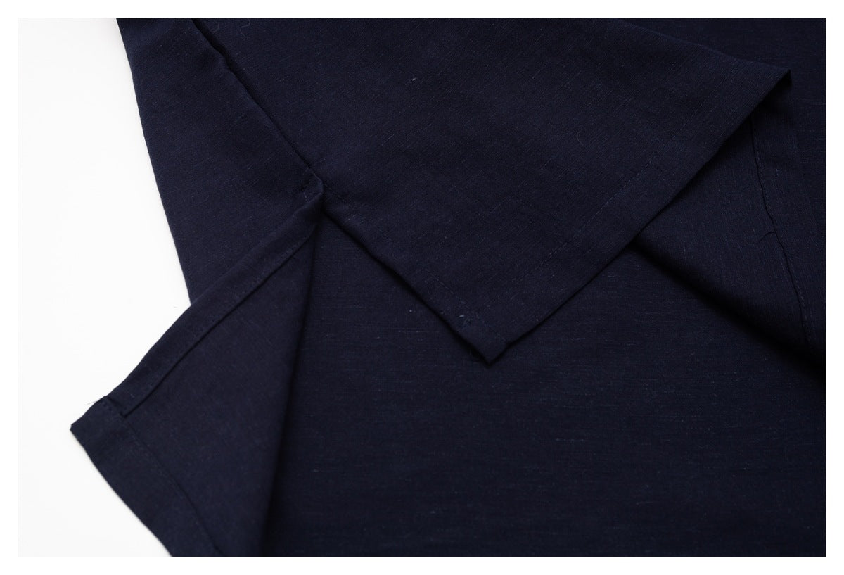 Close-up of a dark navy shirt sleeve and seam construction.