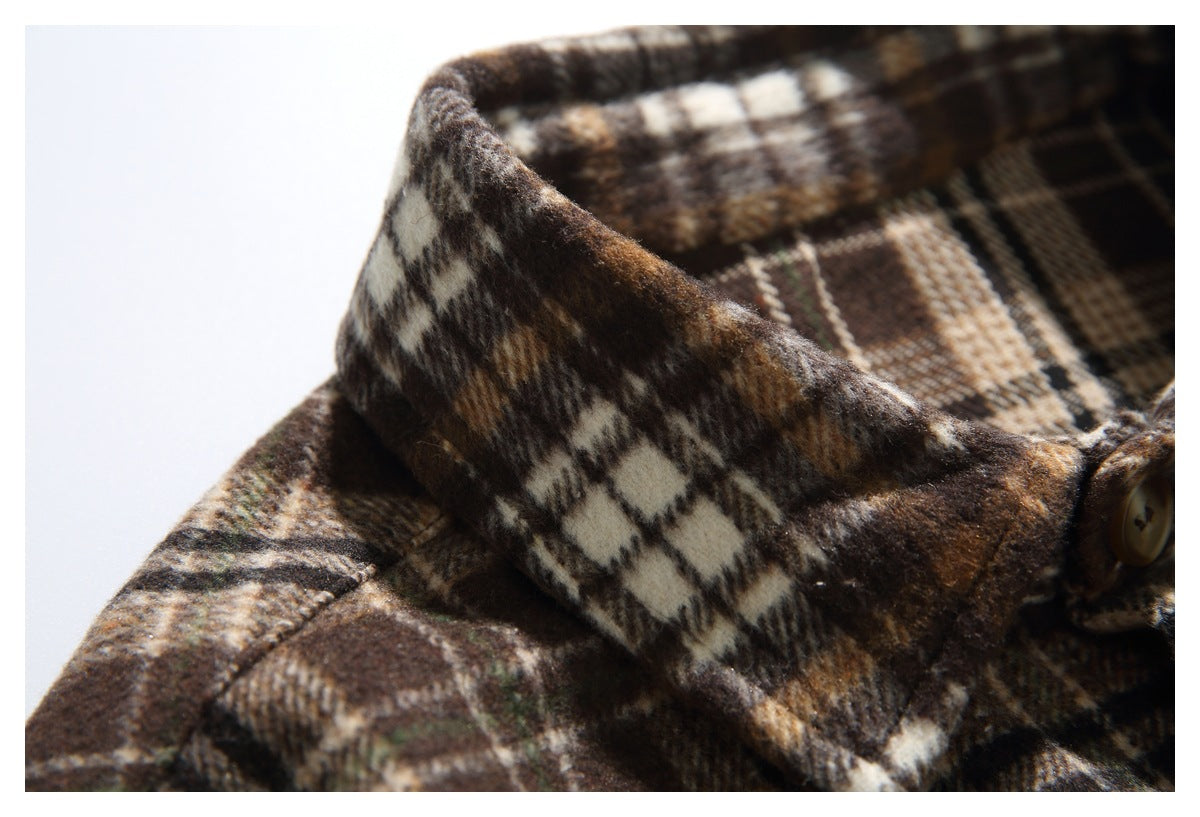 Extreme close-up of the brown and cream plaid shirt's collar and checked pattern.