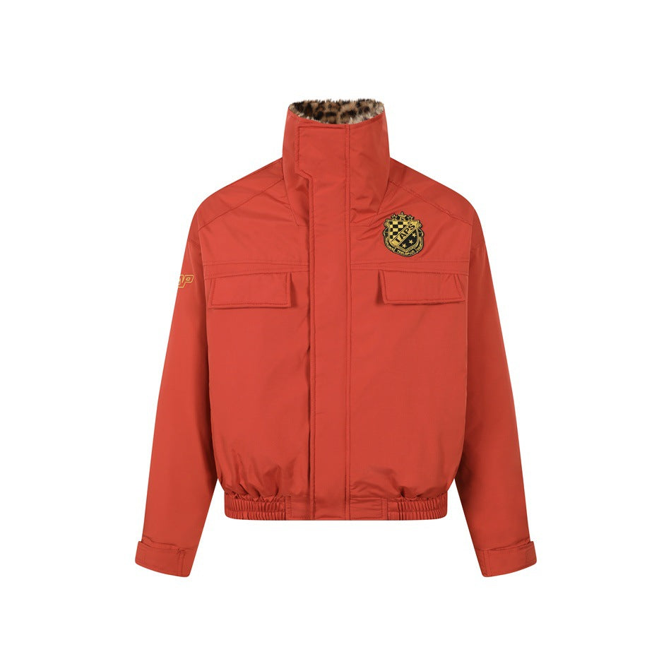 Red bomber-style jacket with high collar, chest flap pockets, crest patch and elastic hem, front view