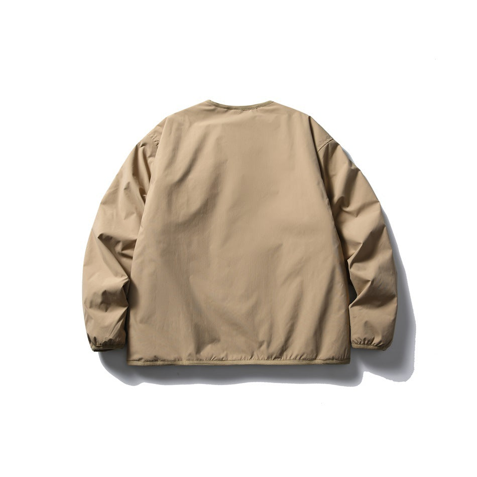 Back view of a plain tan long-sleeved jacket laid flat against a white background.