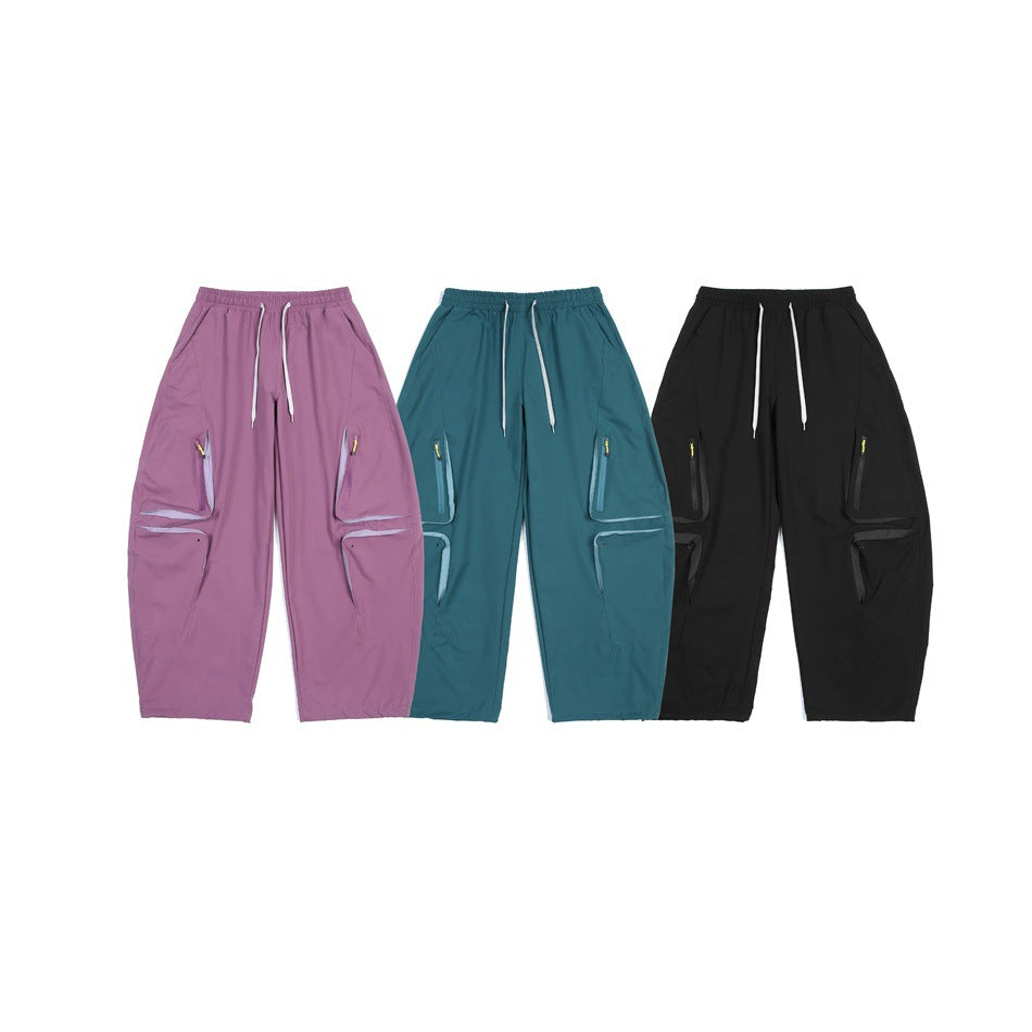 Three pairs of wide-leg cargo pants shown side by side in mauve, teal and black.