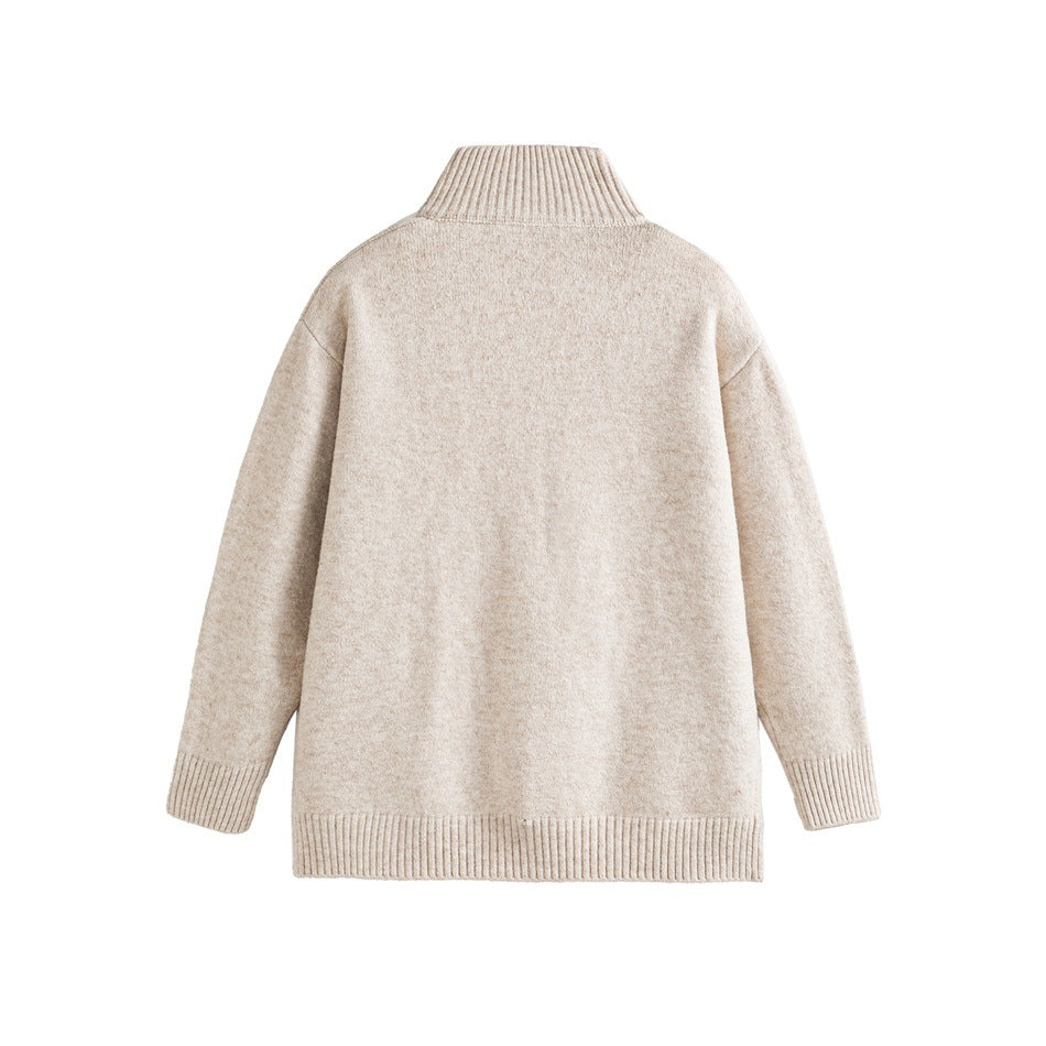 Back view of a light beige high-neck sweater with ribbed collar, cuffs, and hem.