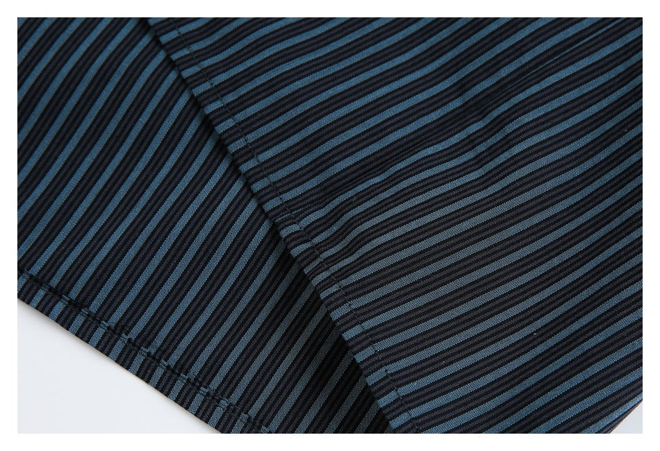 Close-up of the black and blue striped shirt showing a seam and hem stitching.