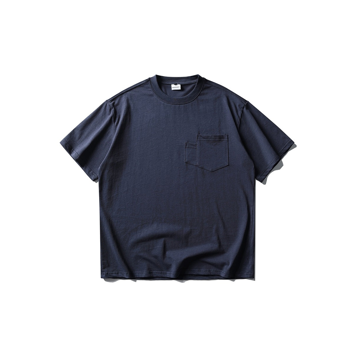 Navy short-sleeve crew neck T-shirt flat lay, front view with two layered chest patch pockets