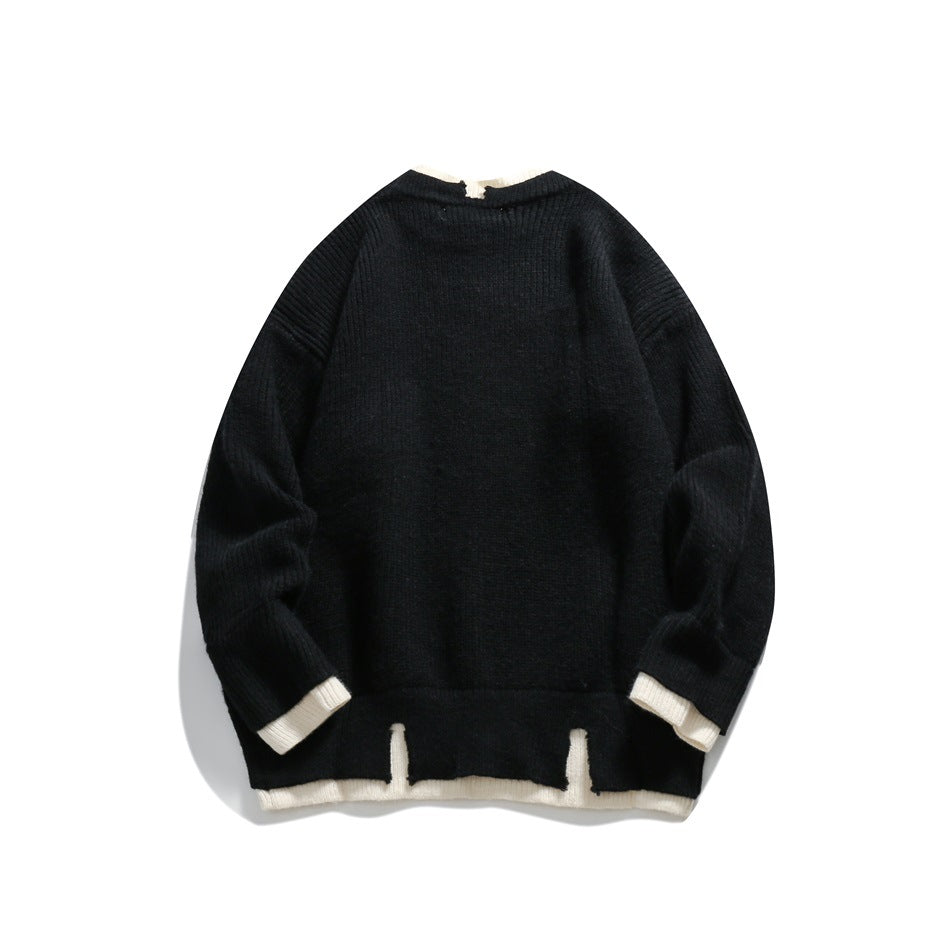 Back view of a black knit sweater with cream trim at the collar, cuffs, and split hem, laid flat on white.
