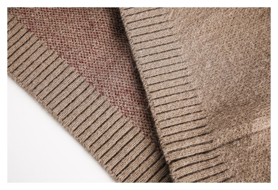 Close-up of taupe-brown knit fabric with ribbed edges and a visible seam with reddish stitching.