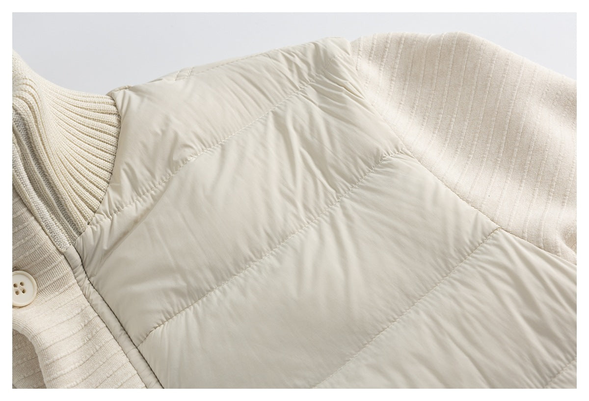 Close-up of a cream quilted vest layered over a ribbed knit garment, showing the padded panels and buttoned trim.