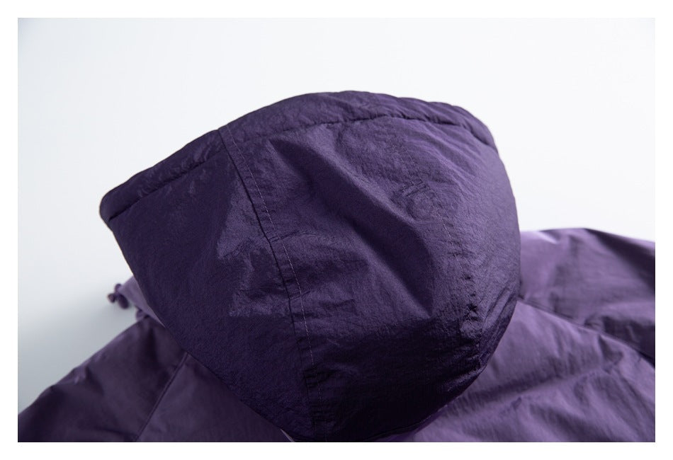 Close-up of the back of a dark purple hood, showing its panel seams and gathered shape.