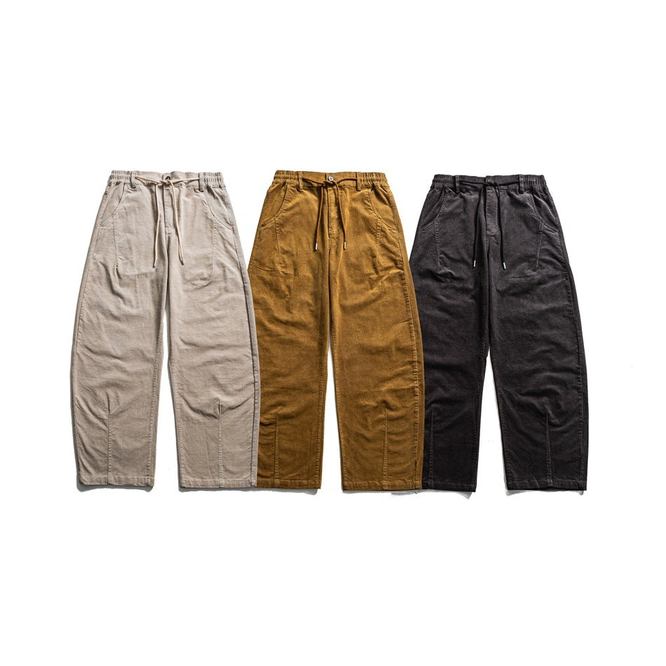 Three pairs of relaxed trousers laid flat, shown from the front in beige, ochre, and charcoal.
