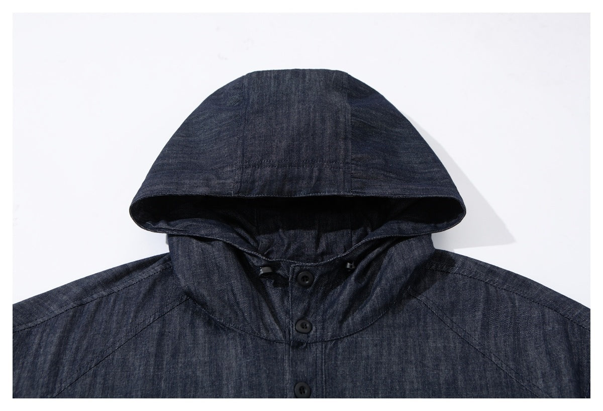 Close-up of the dark indigo jacket's hood, neckline and button placket.