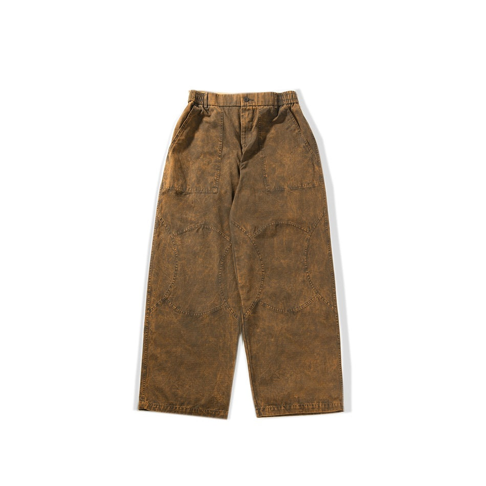 Flat-lay front of brown washed wide-leg pants with elastic waist, patch pockets and curved knee panels