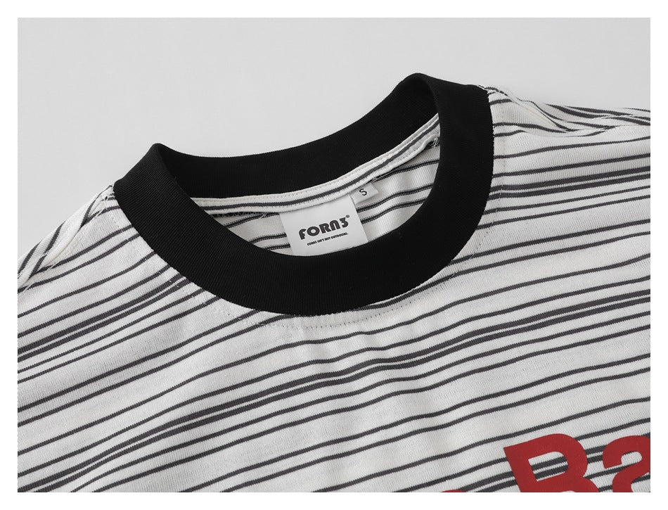 Close-up of a black crew neck and striped white T-shirt, with part of the red chest print visible.
