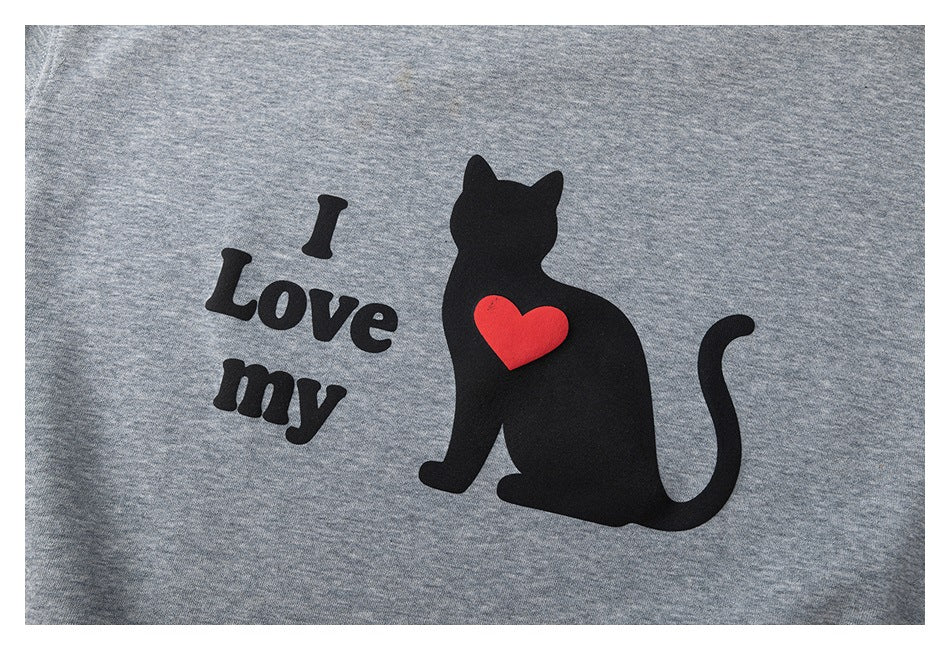Close-up of a gray heather garment with a black cat, red heart, and “I Love my” print.