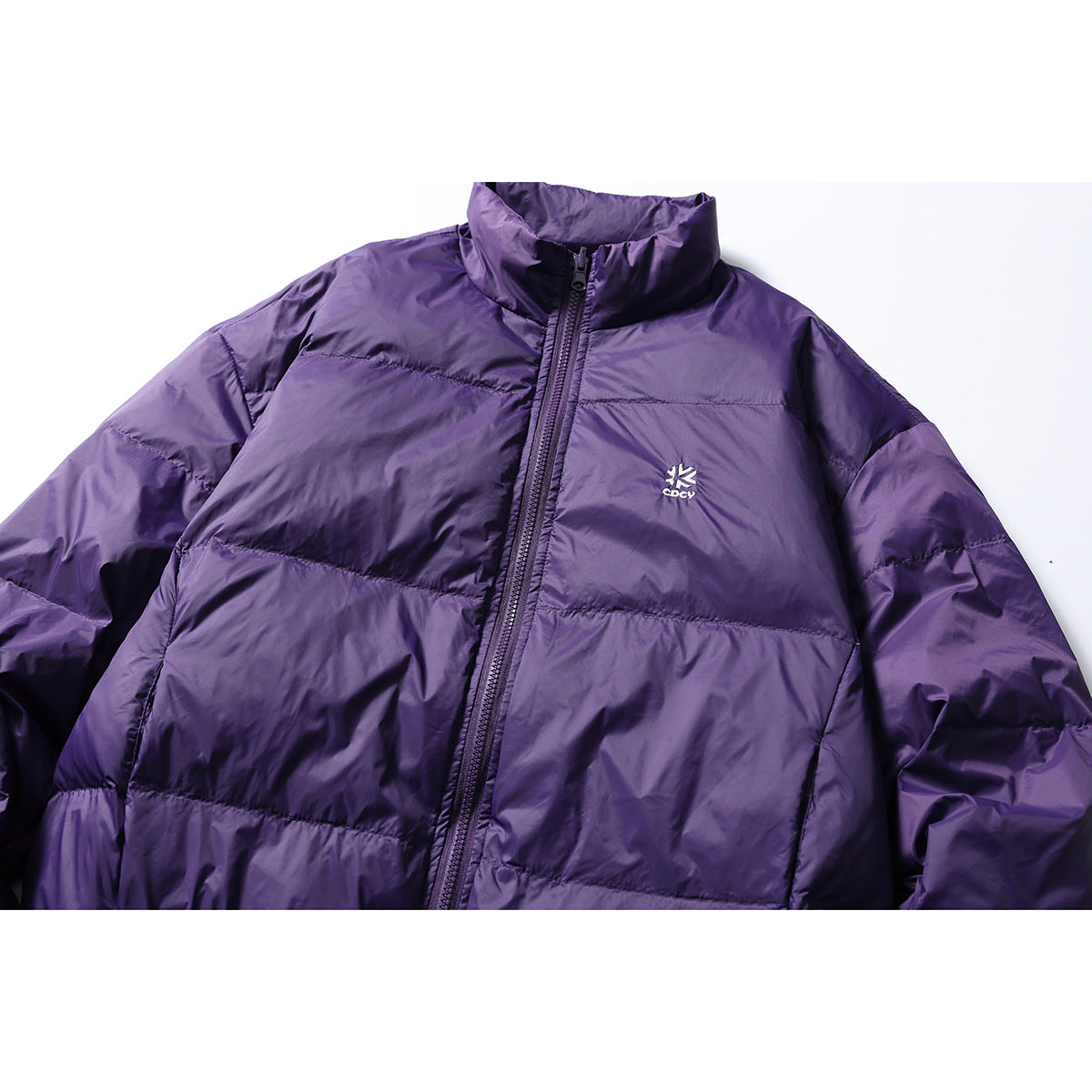Cropped front view of a purple quilted jacket with a stand collar and full-length zipper.
