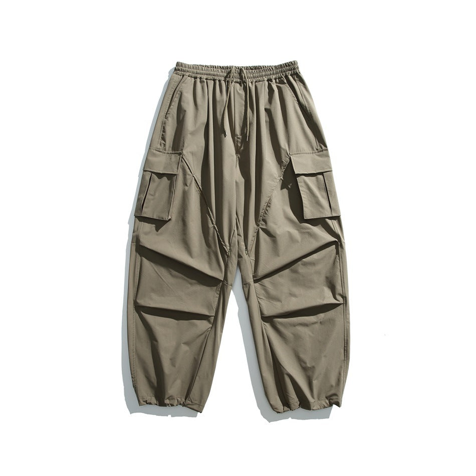 Army green wide-leg cargo pants with drawstring waist, flap thigh pockets and gathered hems, flat lay