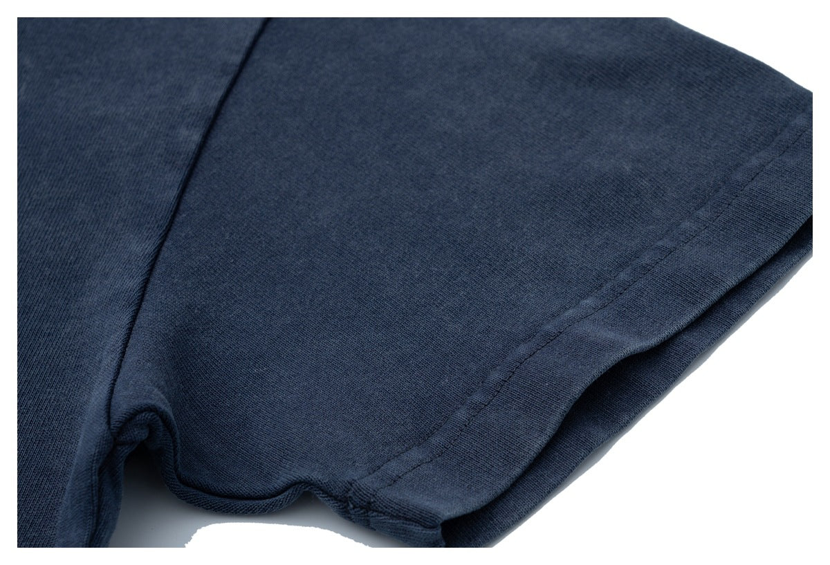 Close-up of the navy shirt's sleeve and stitched hem.