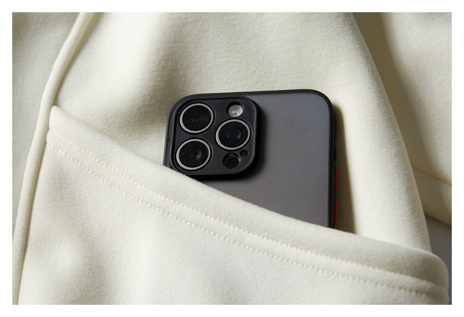 A dark phone sits partly inside the pocket of a cream sweatshirt.