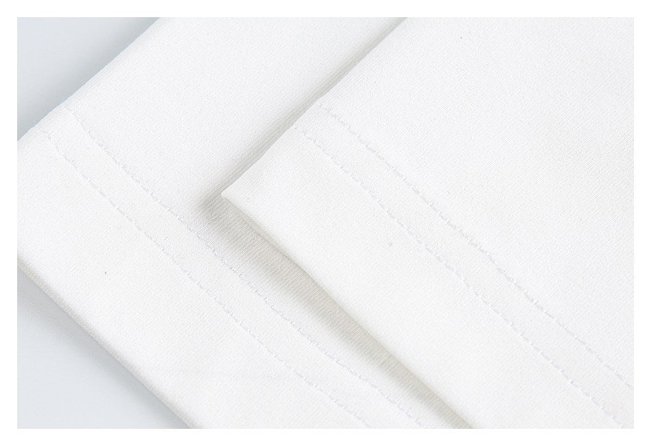 Close-up of a white garment hem with parallel rows of stitching.