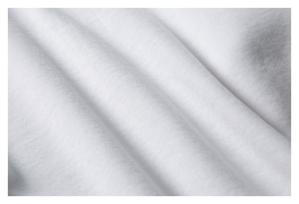 Close-up of softly folded light gray fabric with subtle heathering.