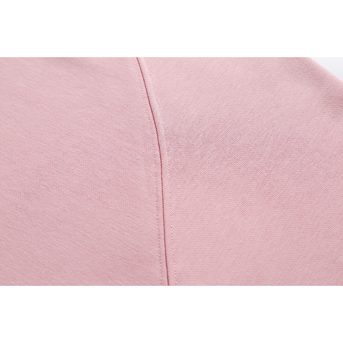Close-up of pink sweatshirt fabric with a stitched seam.