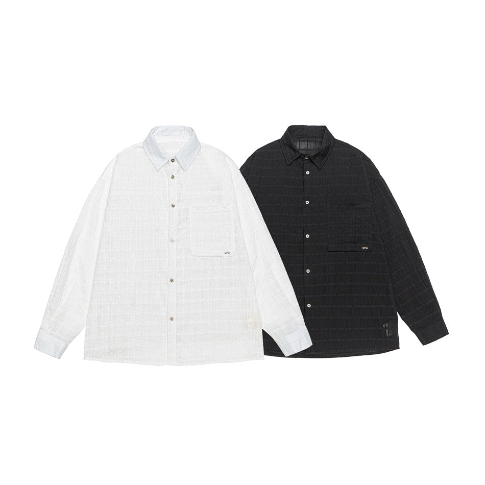 Two button-up shirts shown side by side: white and black, both with long sleeves and chest pockets.