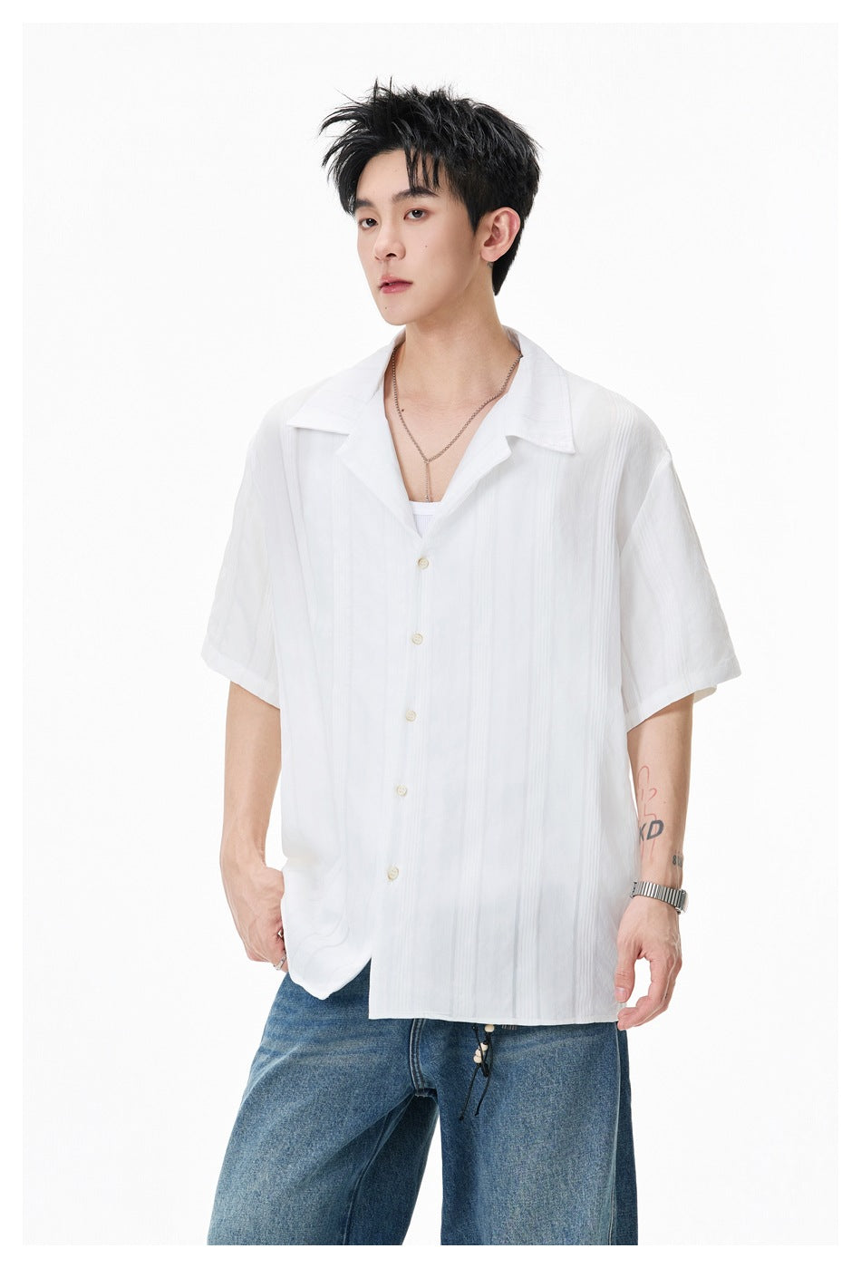 Model wearing a white short-sleeve button-up shirt with a wide collar and subtle vertical stripes.