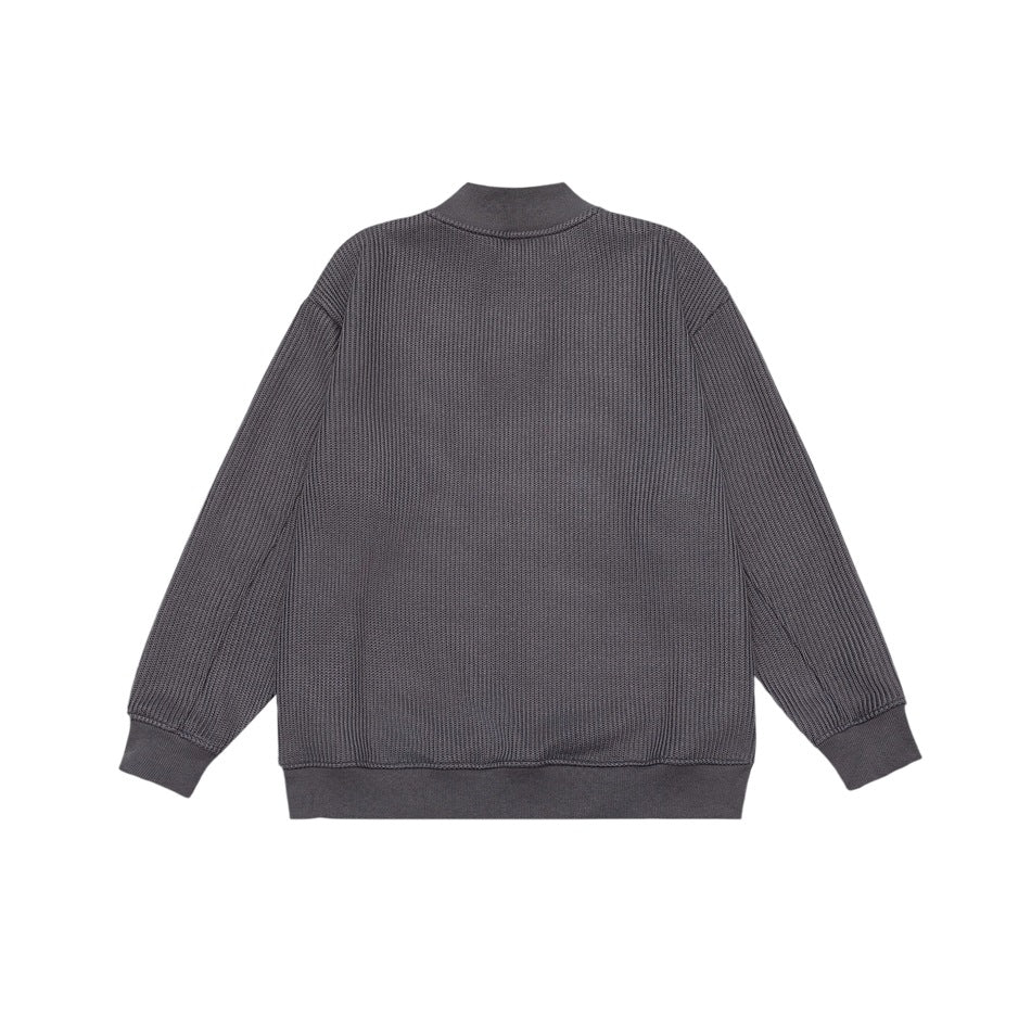 Back view of a charcoal textured knit pullover with a stand collar and ribbed cuffs and hem.