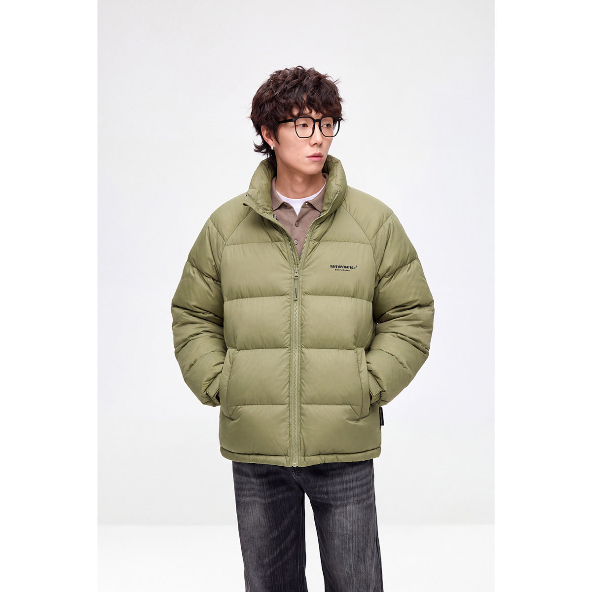 Model wearing an olive-green quilted puffer jacket with a high collar and front zipper.