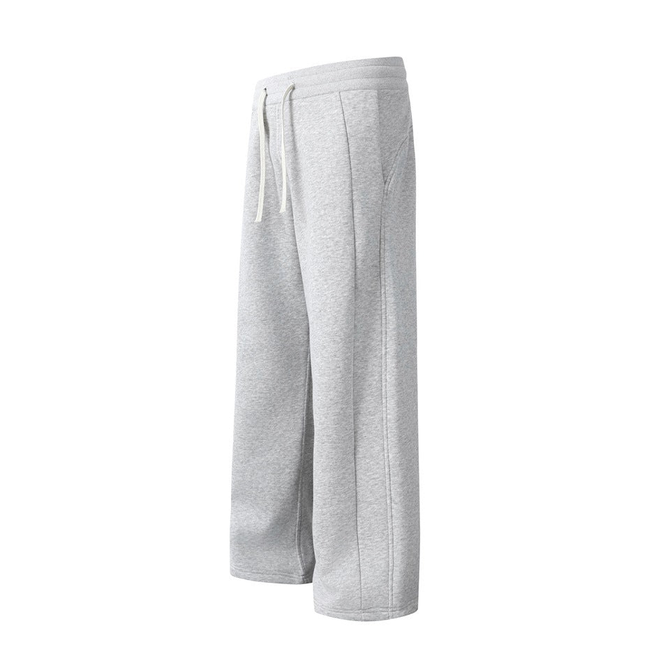 Light gray wide-leg sweatpants shown from the front at an angle, with white drawstrings and side pockets.