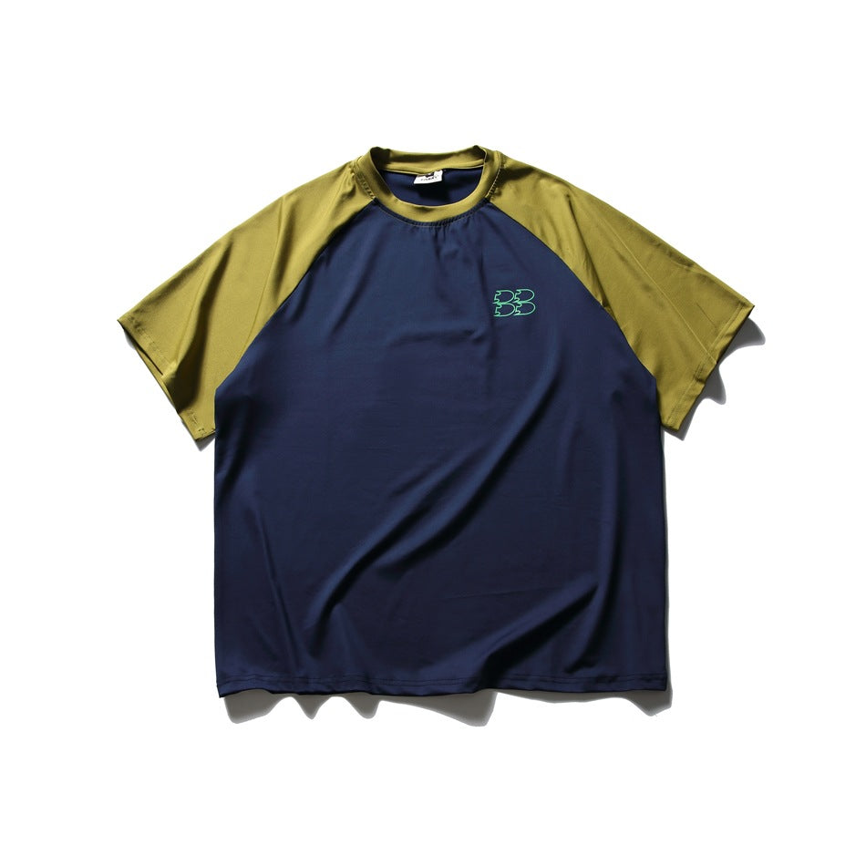 Front view of a navy raglan T-shirt with olive sleeves and a small green chest emblem.