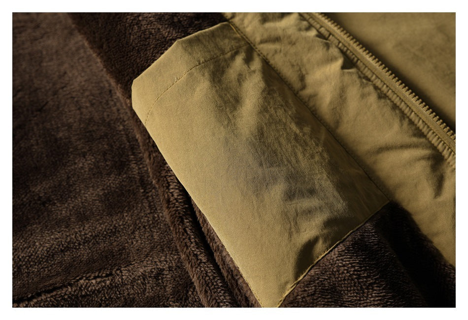 Close-up of a tan jacket pocket and zipper over dark brown plush fabric.