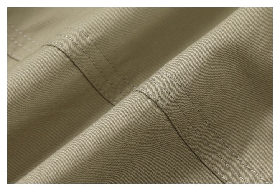 Close-up of a beige garment seam with parallel rows of stitching.