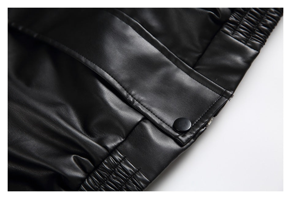 Close-up of a black jacket pocket flap with a snap, stitched seams, and gathered elastic trim.