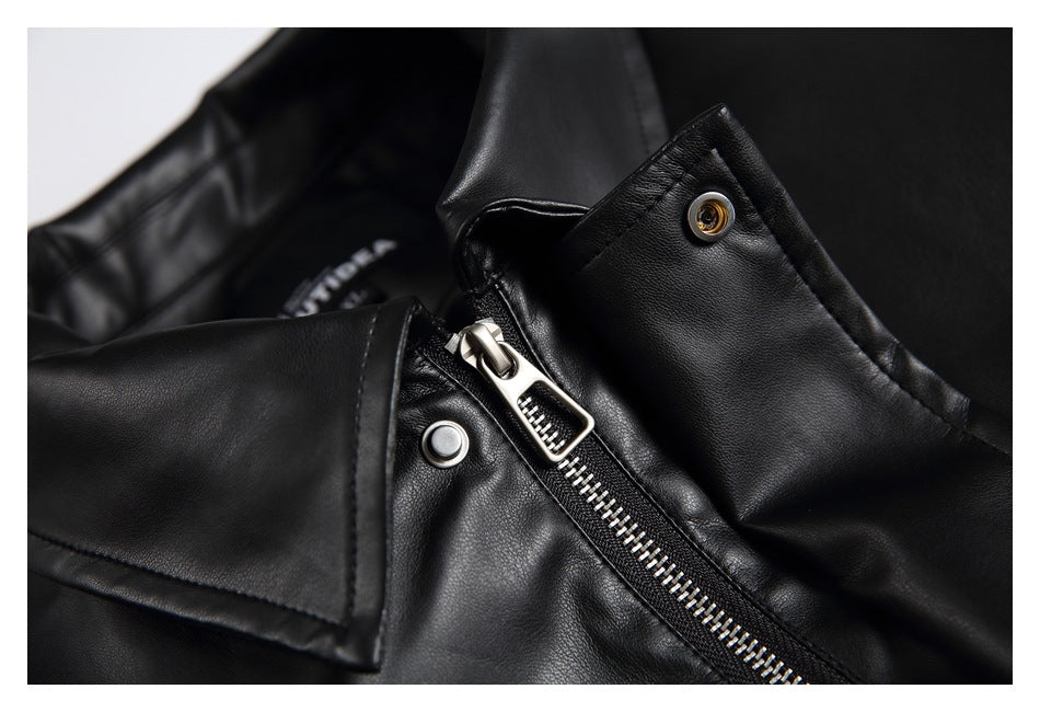 Close-up of a black jacket collar and front zipper with metallic teeth and snap fasteners.
