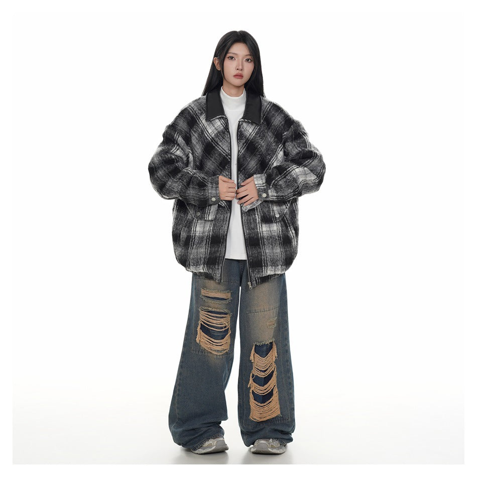 Full-length model wearing a black, gray, and white plaid jacket with a dark collar and front pockets.