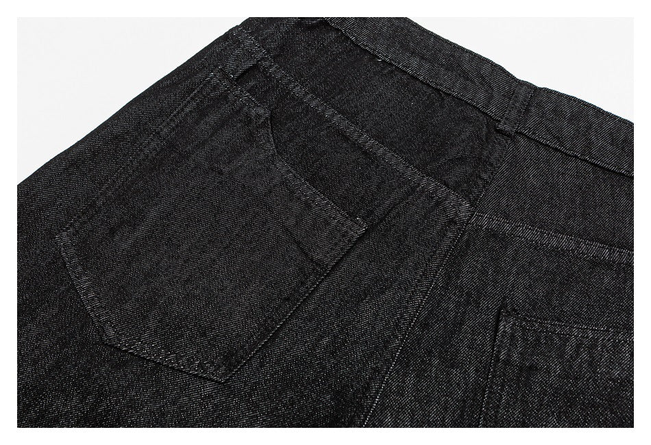 Close-up of a black trouser rear pocket, waistband, and stitching.