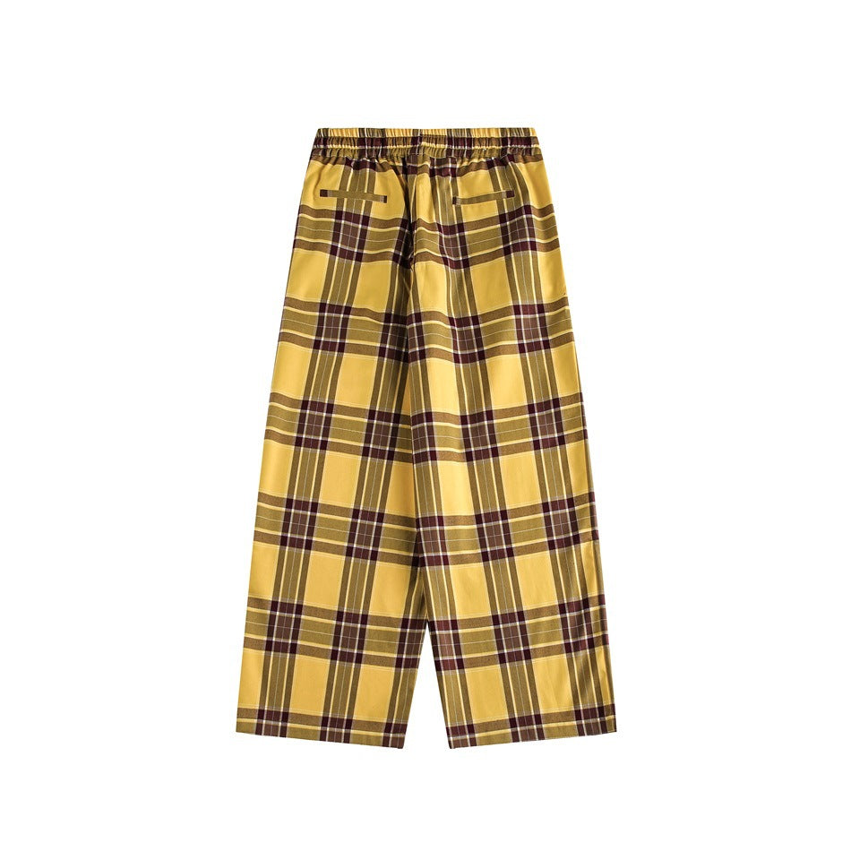 Back view of yellow plaid wide-leg pants showing elastic waistband and two welt-style back pockets