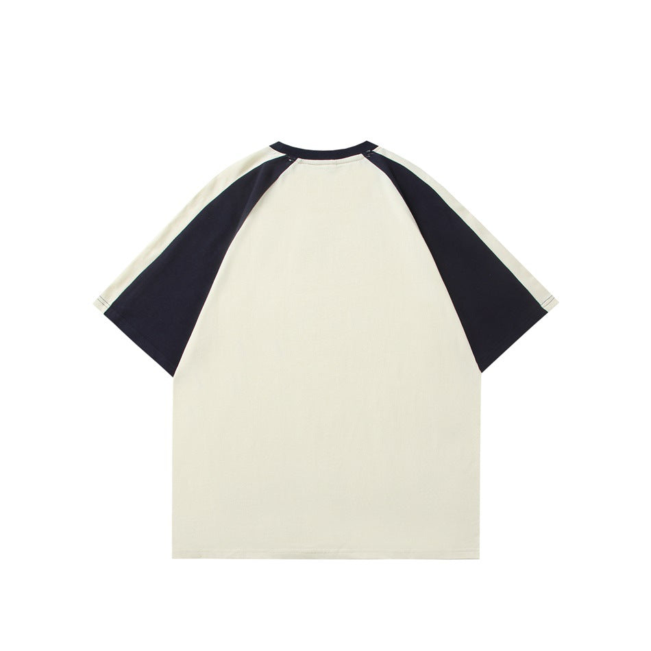 Back view of a cream T-shirt with black raglan sleeves and a black crew neckline.