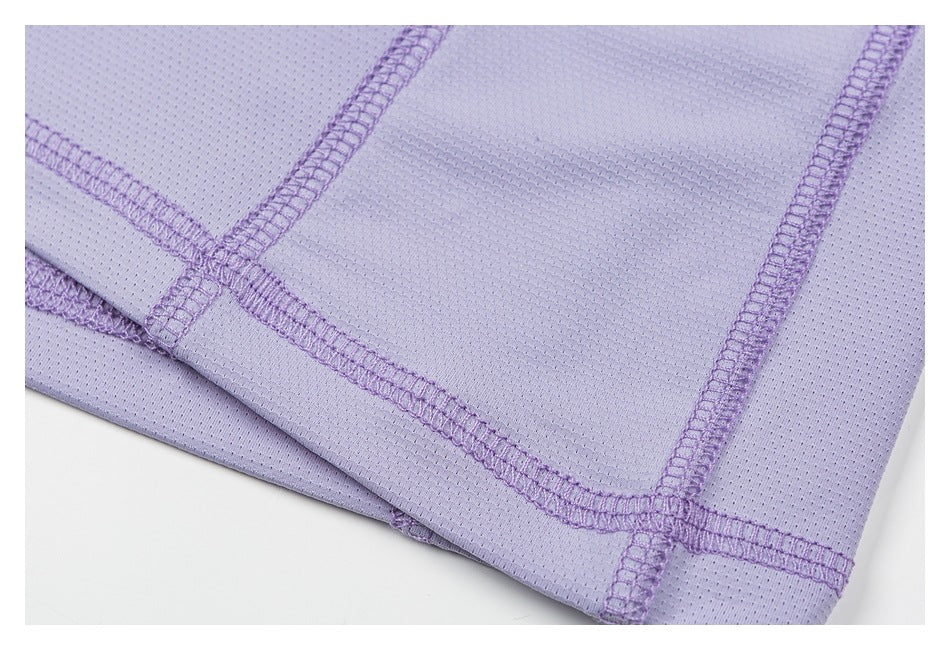 Close-up of lavender perforated fabric showing intersecting purple overlock seams.
