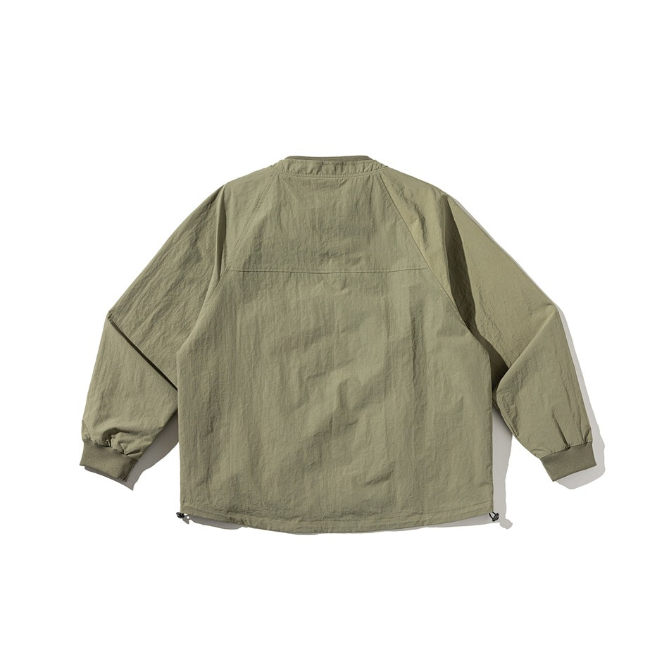 Olive green jacket flat lay, back view, with raglan sleeves, back yoke seam, ribbed cuffs and drawcord hem