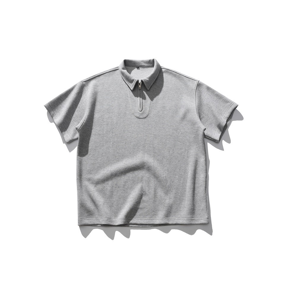 Gray short-sleeve zip-neck polo-style top with pointed collar, laid flat, front view